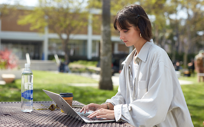 Woman using a laptop computer outdoors